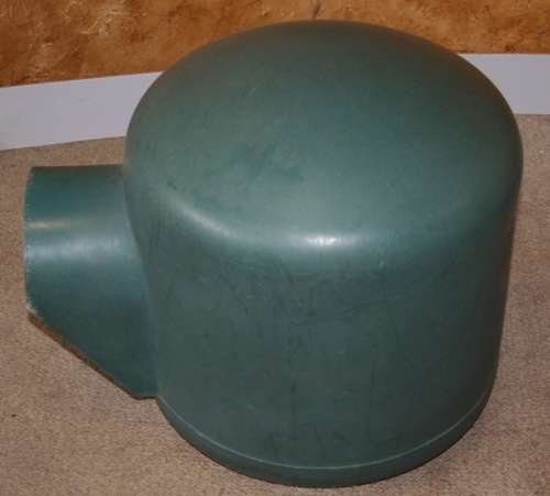 A HARD GREEN PLASTIC DOG KENNEL -