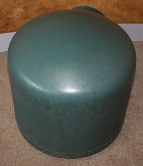 A HARD GREEN PLASTIC DOG KENNEL -