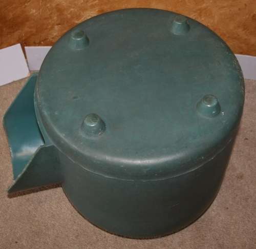 A HARD GREEN PLASTIC DOG KENNEL -