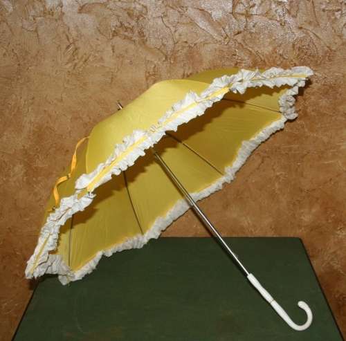This is a neat vintage umbrella in vibrant yellow with a white trim stunning