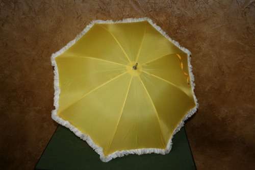 This is a neat vintage umbrella in vibrant yellow with a white trim stunning