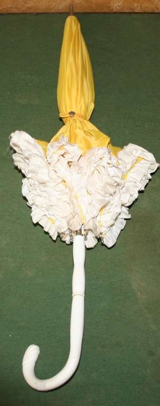This is a neat vintage umbrella in vibrant yellow with a white trim stunning
