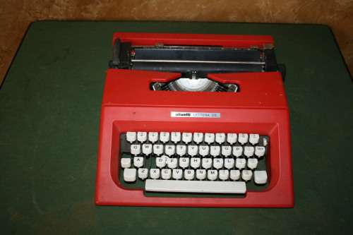 The Olivetti Lettera 25 in a vibrant red is a portable mechanical typewriter