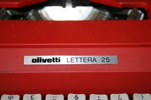 The Olivetti Lettera 25 in a vibrant red is a portable mechanical typewriter