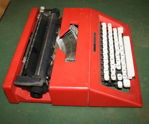 The Olivetti Lettera 25 in a vibrant red is a portable mechanical typewriter