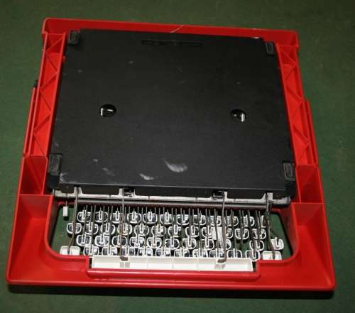 The Olivetti Lettera 25 in a vibrant red is a portable mechanical typewriter