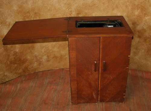 AN INCREDIBLE ANTIQUE  SINGER "TREADLE" SEWING MACHINE IN WONDERFUL CONDITION IN THE ORIGINAL CUPBOA