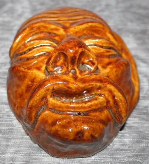 A Gorgeous wayfaring soul, a face with hollowed pupils and a slack mouth seems to stretch outward