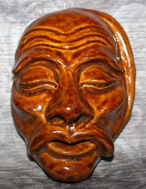 A Gorgeous wayfaring soul, a face with hollowed pupils and a slack mouth seems to stretch outward