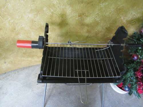 A FANTASTIC HIGH QUALITY FOLD UP BRAAI WITH A LITTLE ROTISSERIE