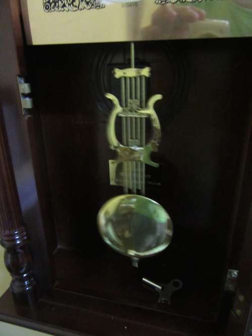 AN EXQUISITE FARAH 31 DAY WALL CLOCKS WITH THE MOST BEAUTIFUL CASE CHIME ON HOUR AND ON HALF HOUR