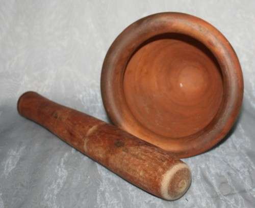 This is a beautiful antique Pottery mortar and pestle. It's handmade and hand carved - very useful