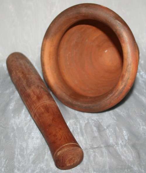 This is a beautiful antique Pottery mortar and pestle. It's handmade and hand carved - very useful