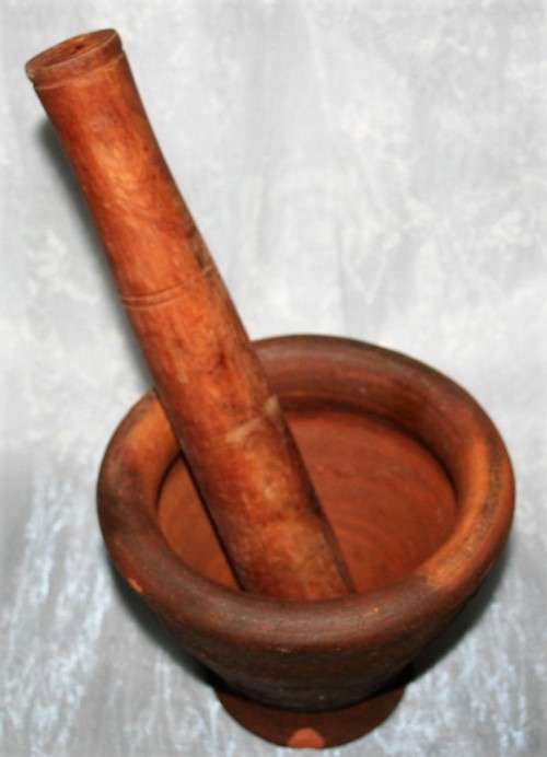 This is a beautiful antique Pottery mortar and pestle. It's handmade and hand carved - very useful