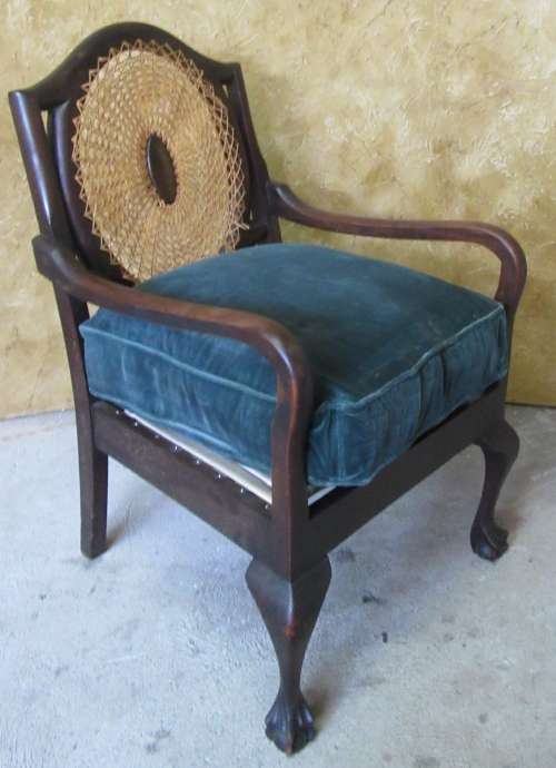 A GORGEOUS SOLID IMBUIA BOW BACKED BALL & CLAW ARM CHAIR WITH A RARE WEAVED RATTAN BACK