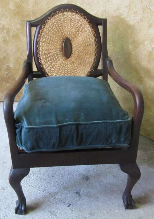 A GORGEOUS SOLID IMBUIA BOW BACKED BALL & CLAW ARM CHAIR WITH A RARE WEAVED RATTAN BACK