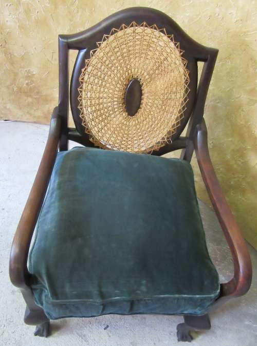 A GORGEOUS SOLID IMBUIA BOW BACKED BALL & CLAW ARM CHAIR WITH A RARE WEAVED RATTAN BACK