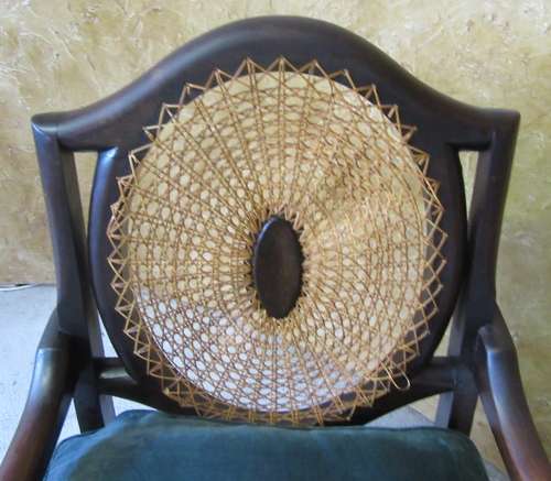 A GORGEOUS SOLID IMBUIA BOW BACKED BALL & CLAW ARM CHAIR WITH A RARE WEAVED RATTAN BACK