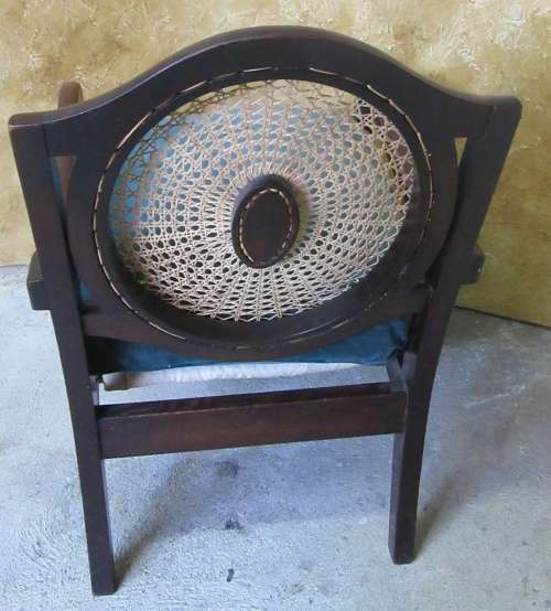 A GORGEOUS SOLID IMBUIA BOW BACKED BALL & CLAW ARM CHAIR WITH A RARE WEAVED RATTAN BACK