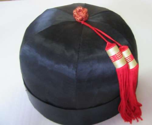 A GORGEOUS BLACK HAT WITH A RED TOSSEL FOR THE HAT COLLECTORS OR FOR THE NEXT HAT PARTY