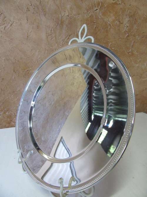 This timeless silver metal under plates will find itself on some of the best tables around.