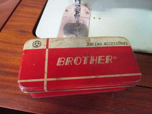 A VINTAGE BROTHER SEWING MACHINE IN A CUPBOARD IN WORKING CONDITION