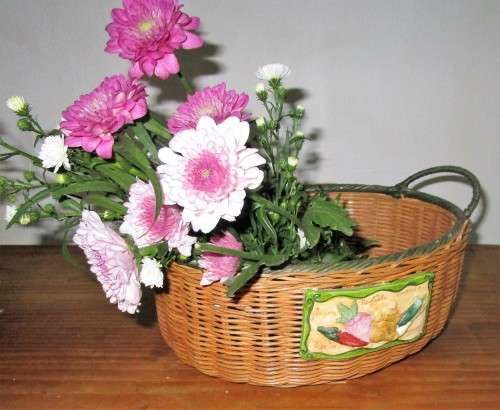 A Gorgeous Country style Oval Wicker Basket with Handles and Ceramic decorative plaque