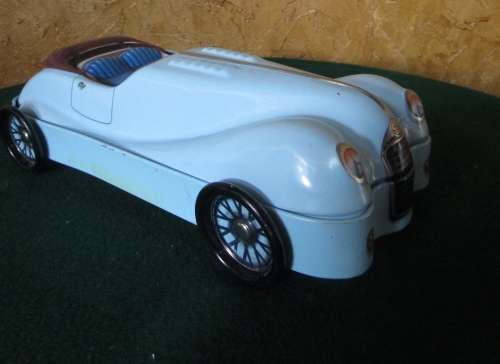 A FANTASTIC CAR SHAPED COOKIE TIN -