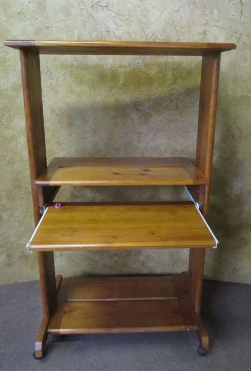 A SOLLID WOD SPACE SAVER DESK WITH A PULL OUT SECTION FOR A COMPUTER KEY BOARD