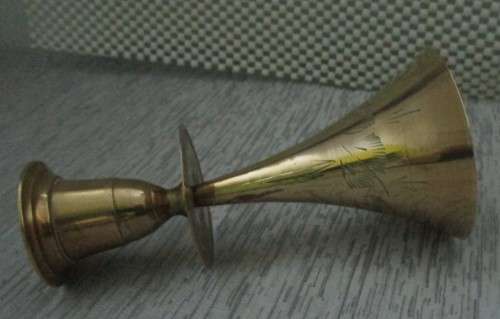 A MARVELOUS BRASS CANLE HOLDER ON TOP AND BELL ON THE BOTTOM SIDE