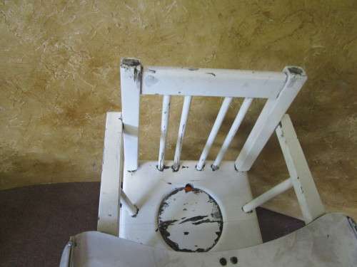 A FANTASTIC VINTAGE BABY HIGH CHAIR WITH A POTTY WHOLE AND IT FOLDS DOWN ON WHEELS PLEASE SEE PICTUR