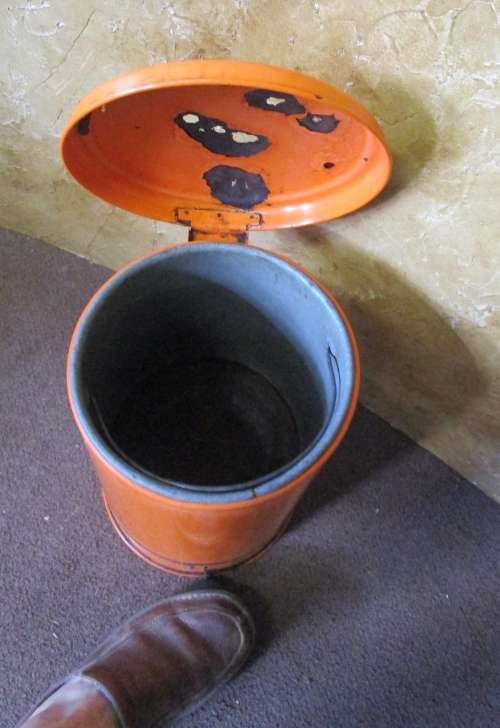 A BRIGHT ORANGE VINTAGE ENAMEL PEDTAL BIN IN WORKING CONDITION