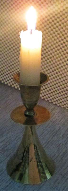 A MARVELOUS BRASS CANLE HOLDER ON TOP AND BELL ON THE BOTTOM SIDE
