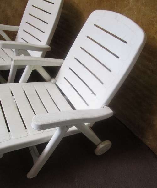 TWO FANTASTIC WHITE FOLD UP LOUNGERS ON WHEELS PERFECT FOR THIS SUMMER WEATHER BID PER EACH