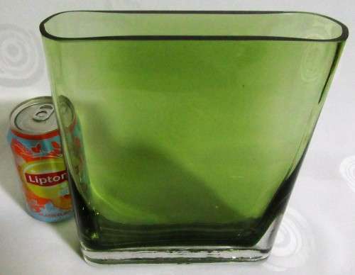 A heavy decorative flower Vase. It's made of an emerald green glass in a modern rectangular shape
