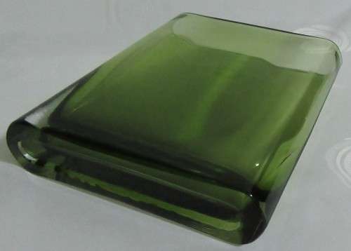 A heavy decorative flower Vase. It's made of an emerald green glass in a modern rectangular shape