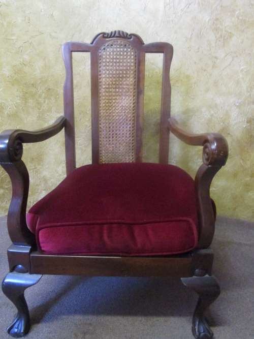A GORGEOUS SOLID IMBUIA BOW BACKED BALL & CLAW ARM CHAIR WITH A RARE WEAVED RATTAN BACK