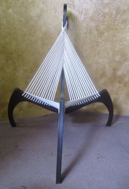 A EXQUISITE DESIGNER CHAIR WITH A DARK WOOD AND ROPE DESIGN ABSOLUTELY STUNNING