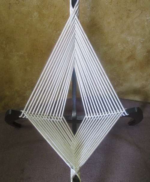 A EXQUISITE DESIGNER CHAIR WITH A DARK WOOD AND ROPE DESIGN ABSOLUTELY STUNNING