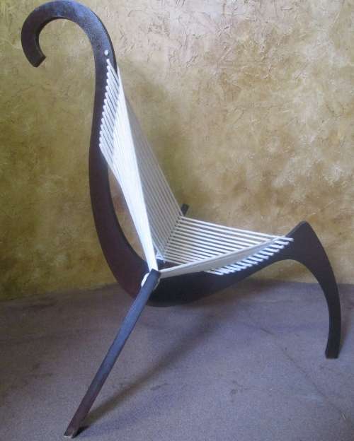 A EXQUISITE DESIGNER CHAIR WITH A DARK WOOD AND ROPE DESIGN ABSOLUTELY STUNNING