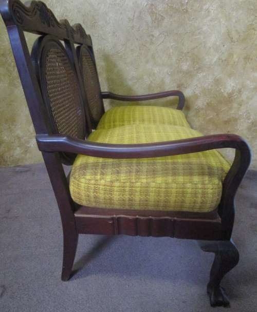 A beautiful solid Wood Ball & Claw parlour couch with wicker backrest in great condition!!!