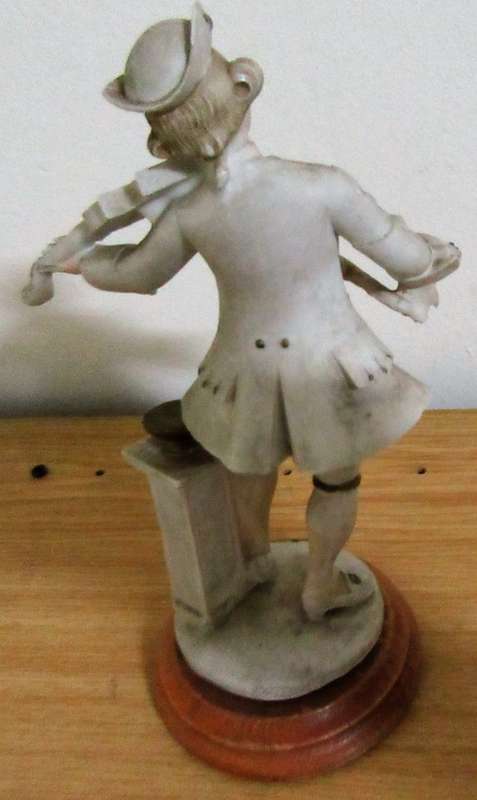 A DELIGHTFUL ITALIAN FIGURINE MOUNTED ON WOOD OF A MAN PLAYING THE VILON