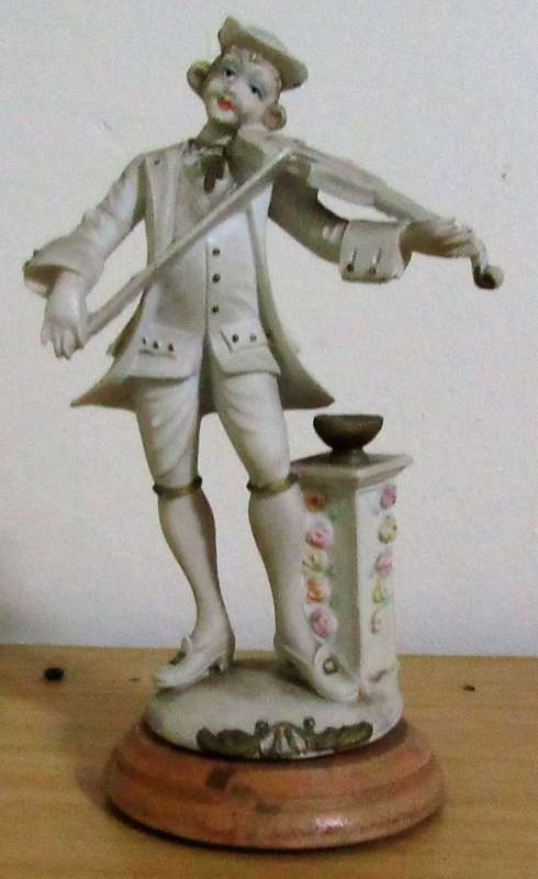 A DELIGHTFUL ITALIAN FIGURINE MOUNTED ON WOOD OF A MAN PLAYING THE VILON