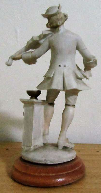 A DELIGHTFUL ITALIAN FIGURINE MOUNTED ON WOOD OF A MAN PLAYING THE VILON