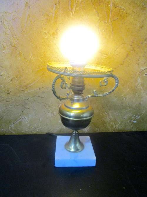 This is a gorgeous brass lamp with a large finial and a marble base