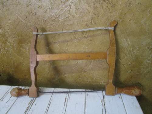 A lovely antique bow cut saw in wonderfully weathered condition with a great primitive look and feel