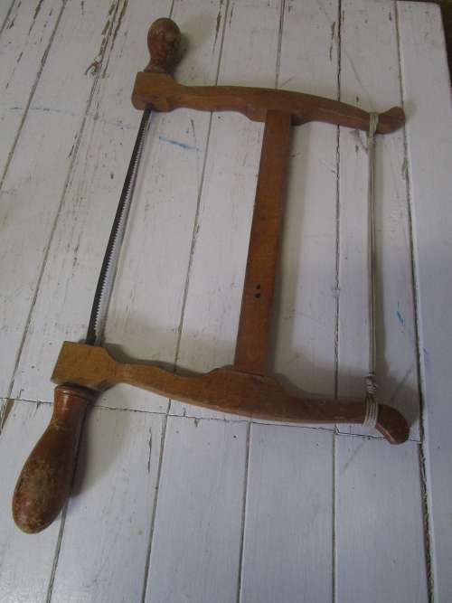 A lovely antique bow cut saw in wonderfully weathered condition with a great primitive look and feel