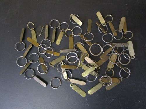 A JOBLOT OF NUMBERED BRASS KEY RINGS ONE BID FOR ALL