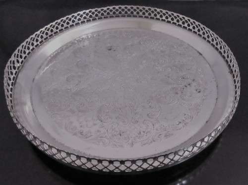 A Vintage Silver plated serving tray - Tray is round, has a pierced gallery edge and a ornate chased