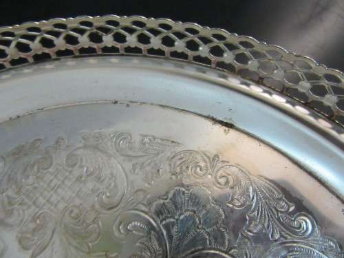 A Vintage Silver plated serving tray - Tray is round, has a pierced gallery edge and a ornate chased